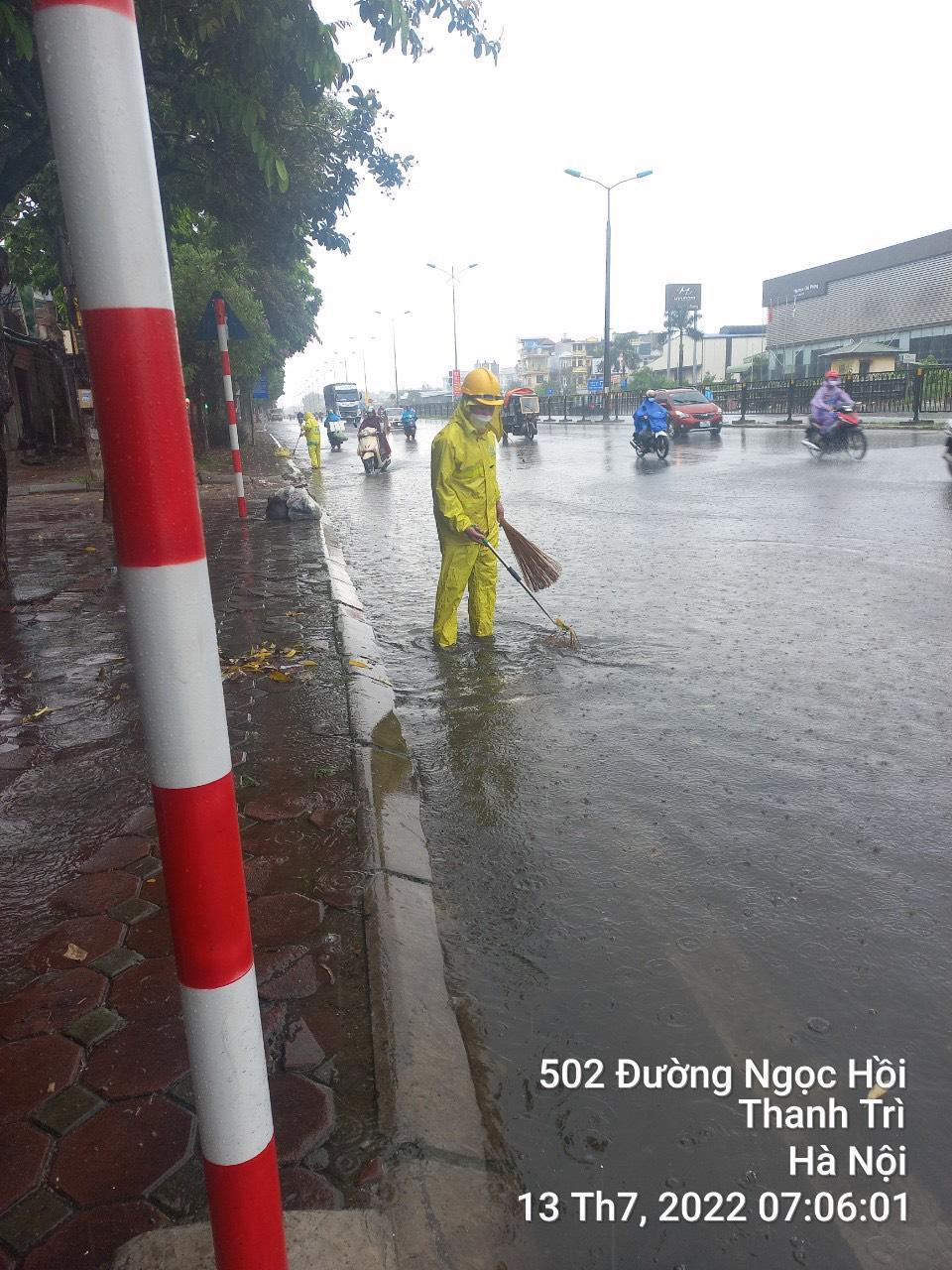 Lực lượng chức năng thực hiện thoát nước trên đường Ngọc Hồi, huyện Thanh Trì sáng 13/7.