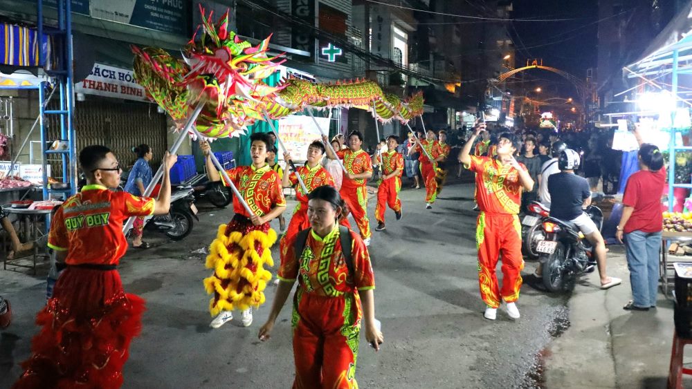 Giữa những âm thanh náo nhiệt của tiếng trống, kèn, múa lân, đoàn người đưa Sắc Thần du ngoạn cũng hòa chung không khí vui tươi, rộn ràng. Người già đến trẻ nhỏ đứng chật kín hai bên đường để đón Sắc Thần đi qua.