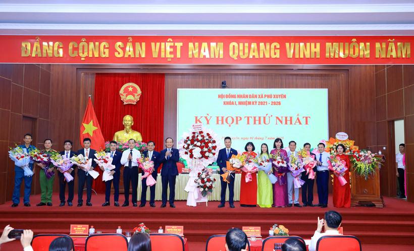 Chủ tịch HĐND TP. Hà Nội Nguyễn Ngọc Tuấn tặng hoa chúc mừng lãnh đạo HĐND, UBND xã Phú Xuyên. Ảnh: LN