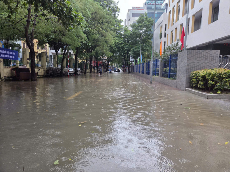 Cổng Trường Tiểu học Nghĩa Đô bị ngập nước, nhà trường đã chủ động cho học sinh ở nhà học trực tuyến.